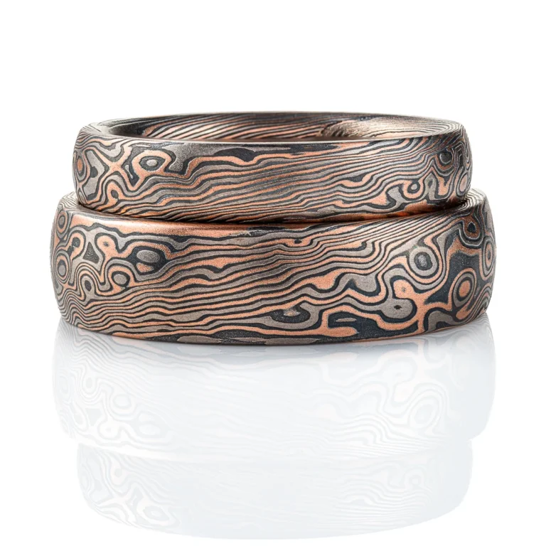 Dark palette mokume gane patterned ring, made in combination pattern with twisted and droplet style elements. Shown here in a combination of red gold, palladium and oxidized silver