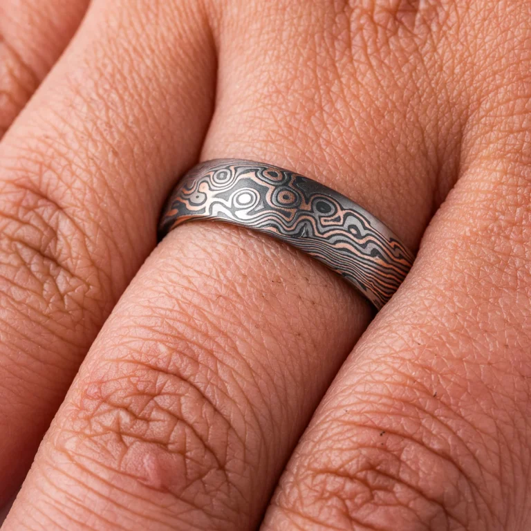 Dark palette mokume gane patterned ring, made in combination pattern with twisted and droplet style elements. Shown here in a combination of red gold, palladium and oxidized silver