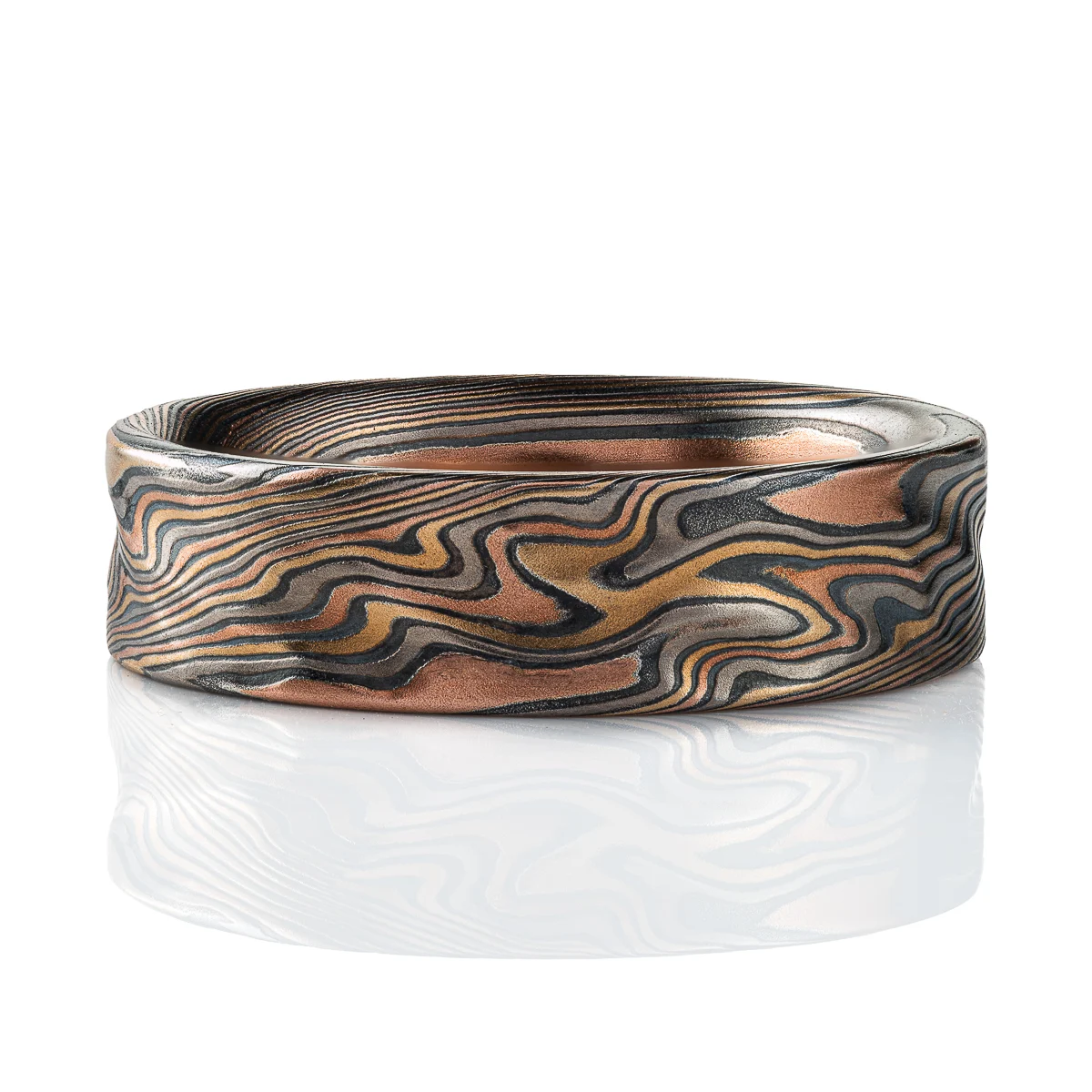 Twisting mokume gane pattern ring in multicolor palette with surface texture.