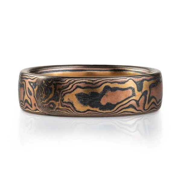 mokume gane woodgrain style patterned ring, made with red gold, yellow gold and oxidized silver