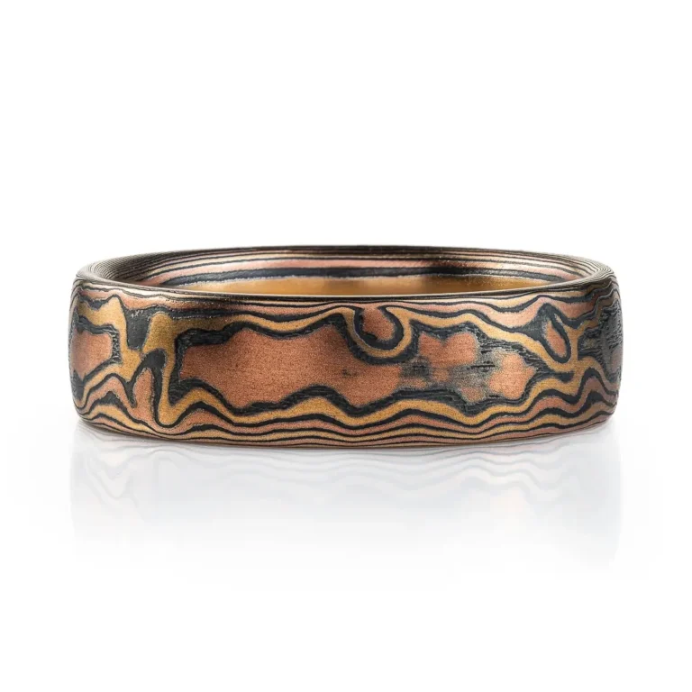 mokume gane woodgrain style patterned ring, made with red gold, yellow gold and oxidized silver