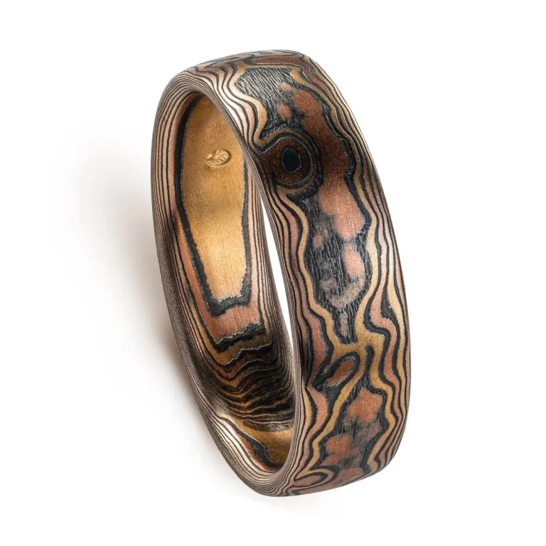 mokume gane woodgrain style patterned ring, made with red gold, yellow gold and oxidized silver