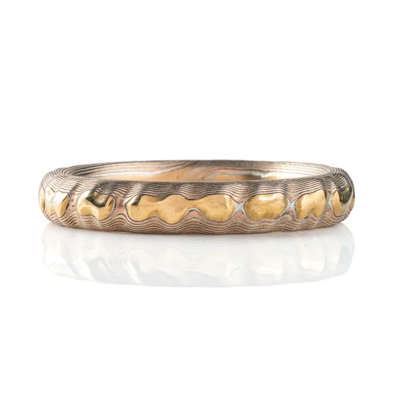 Slim elegant mokume gane ring in Arn Krebs signature Guri Bori pattern, resembling the texture of rock and mountain ranges.