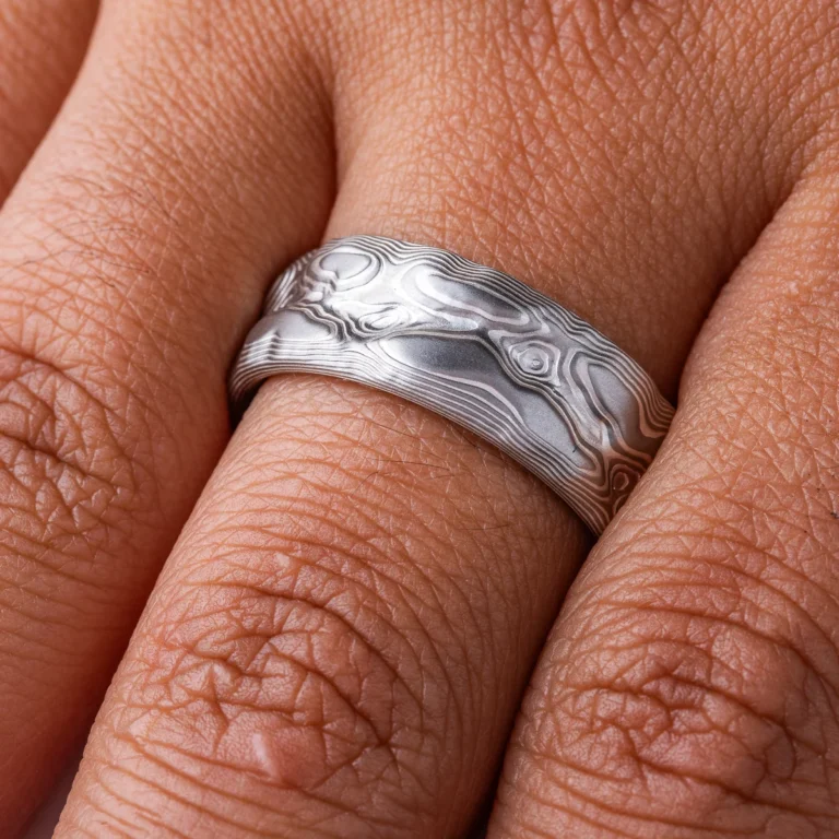 Ring patterned in a topographic style that resembles rocks and mountains, silver and light gray color combination.