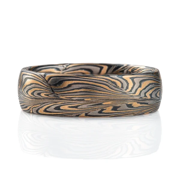 One of a kind organically patterned ring, with swoops and waterlike movement. Made with layers of yellow gold, palladium and oxidized silver.