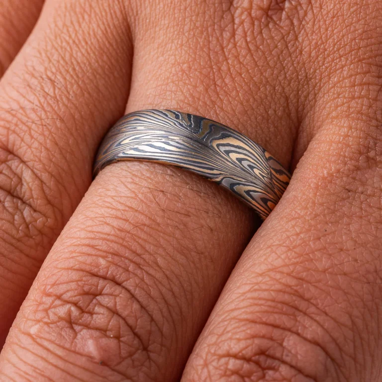 One of a kind organically patterned ring, with swoops and waterlike movement. Made with layers of yellow gold, palladium and oxidized silver.