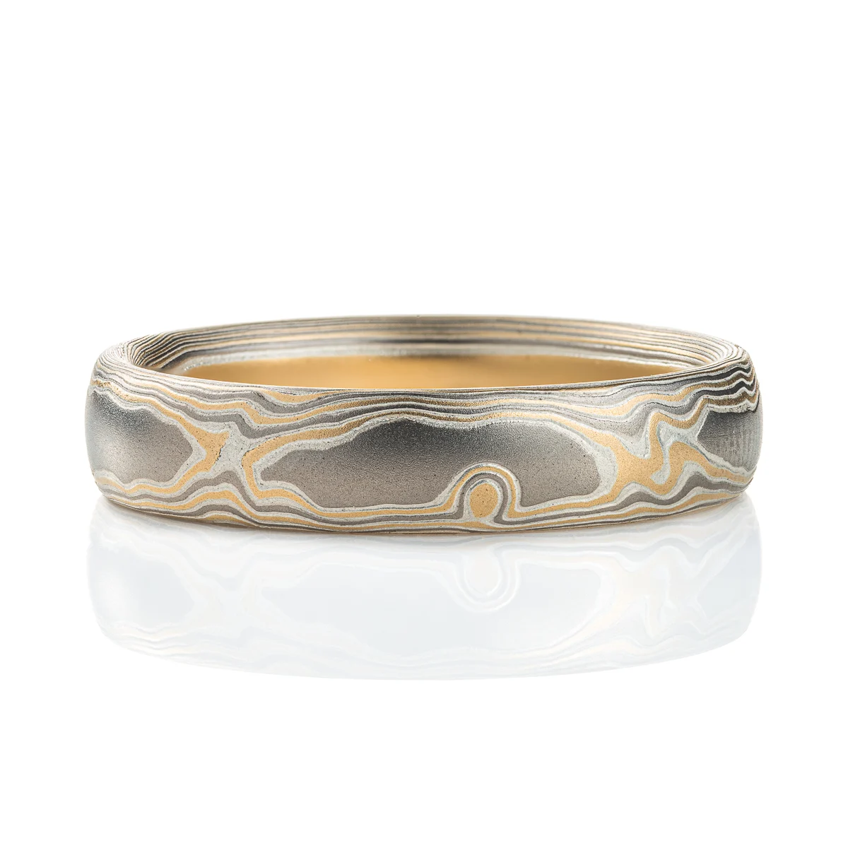 Slightly domed woodgrain mokume gane band, made with yellow gold, palladium (dark gray) and silver (light gray).