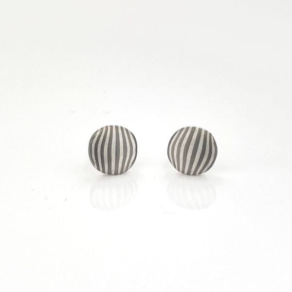 These earrings are available and ready to ship upon purchase! These elegant stud earrings are made in our Ash palette, featuring palladium, and silver. They feature a gently waving pattern for just a touch of movement, and a smooth satin finish.