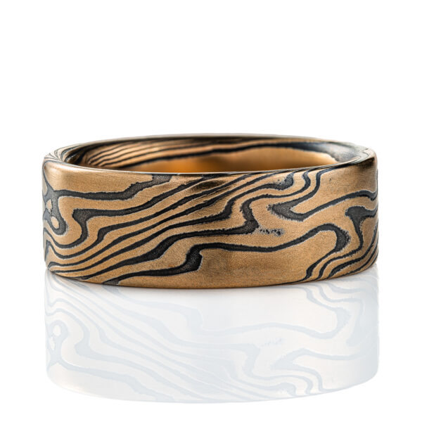 High contrast yellow gold and black ring, made in mokume twist pattern, alternating stripes of black and yellow.