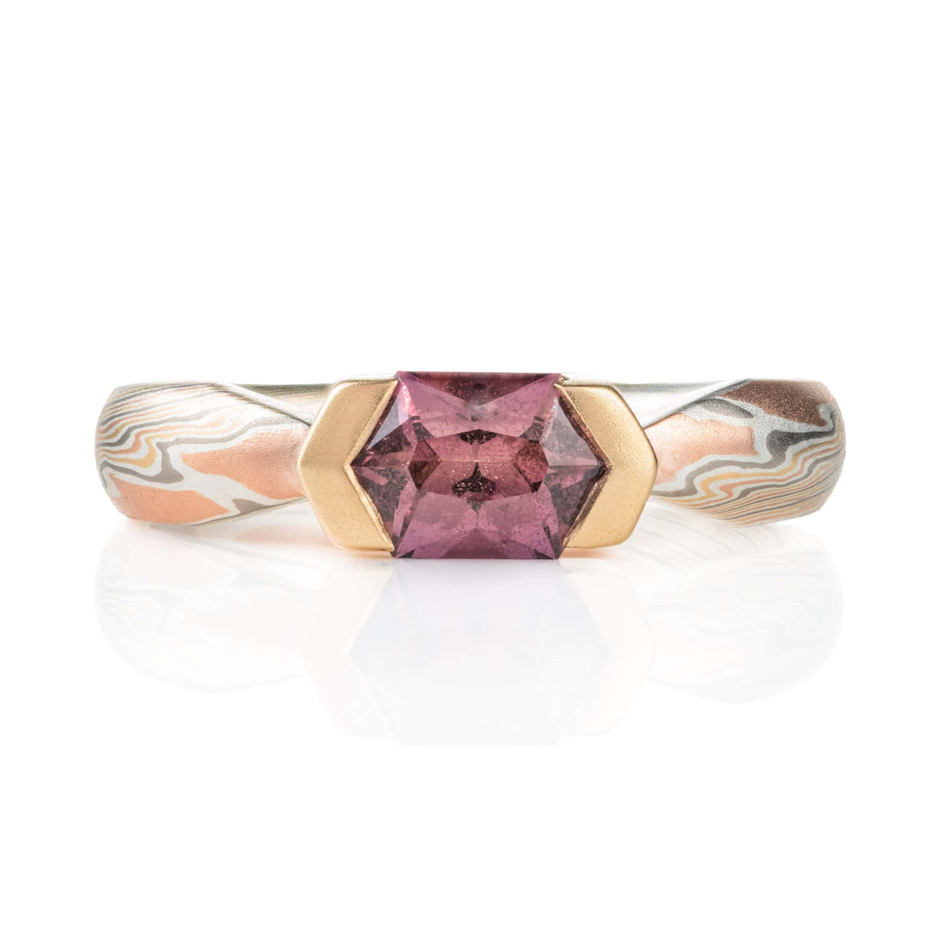 Mokume gane engagement ring with pink long hexagon shaped stone.