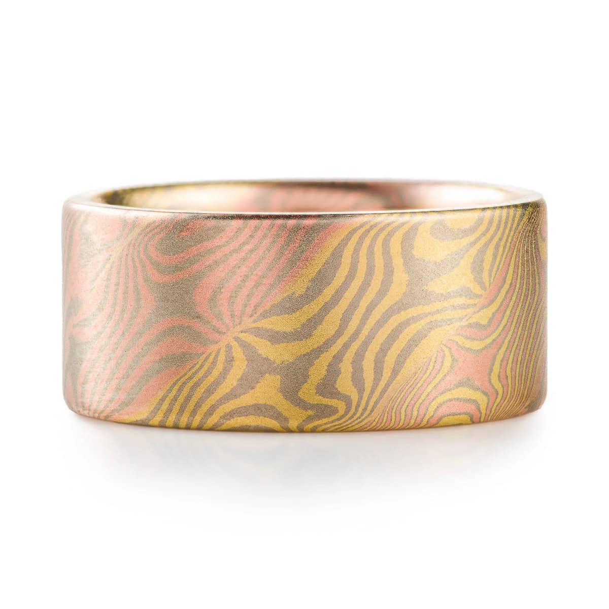 Flat profiled wide mokume gane men's band, made of many different metal colors fused and twisted together. Red, yellow and dark warm gray metals.