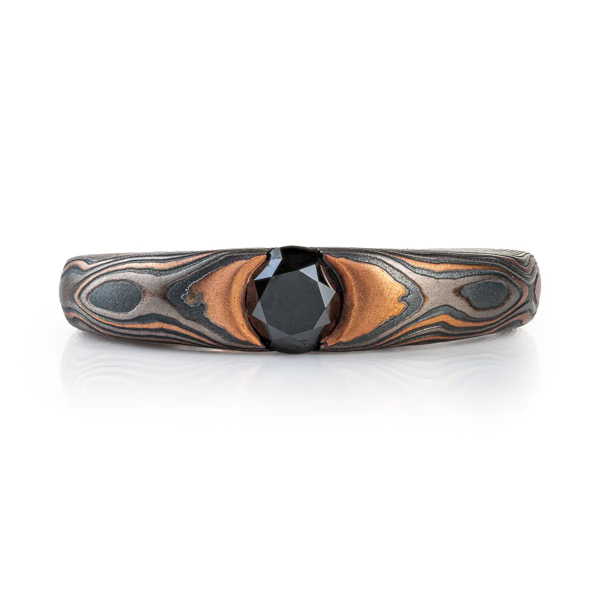 Mokume gane wood grain patterned ring with a black diamond.