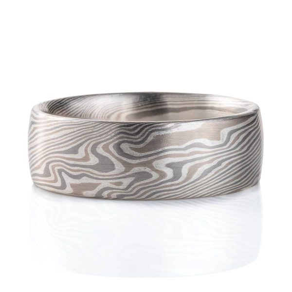 Wide, smooth finish mokume gane patterned ring, made with three different metal colors, ranging from light to dark gray.