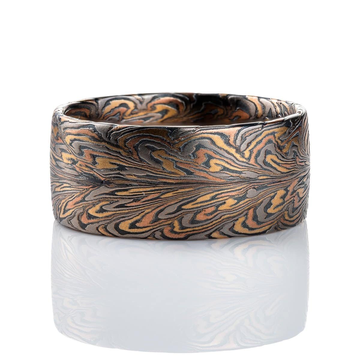 Wide mens ring mokume gane patterned to resemble the fibers of a feather, made with red and yellow gold, palladium, and oxidized silver (black) in thin layers.