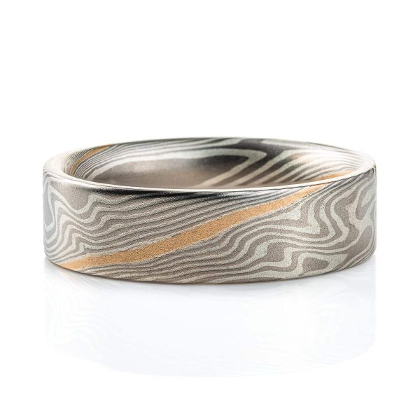 Flat profile ring made in mokume gane twist pattern, with layers of light and dark gray metals, and one layer of yellow gold.