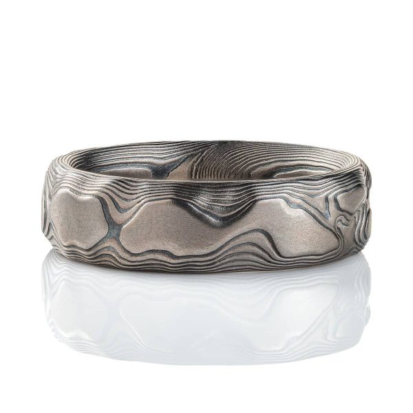 Gray and black mokume gane patterned ring, made to look like topographic/rock texture.