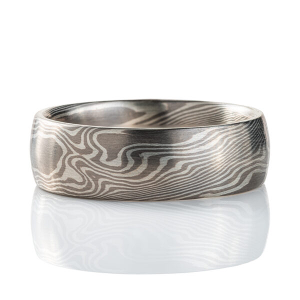 Wide mokume gane patterned ring, domed profile, made with light and dark gray metals.