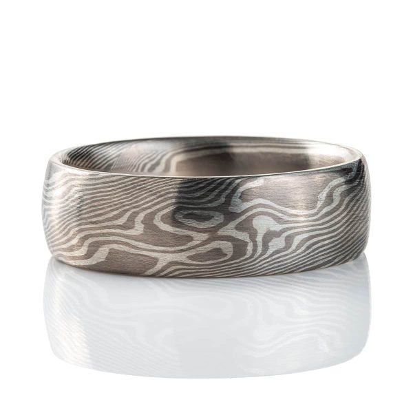 Wide mokume gane patterned ring, domed profile, made with light and dark gray metals.