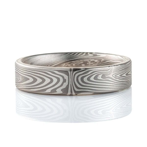 Narrow, flat profile band, mokume gane pattern in a linear style, made with palladium and silver for an overall silvery/gray color palette.
