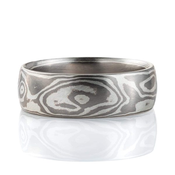 Smooth, domed ring, made in a mokume gane woodgrain pattern, in a combination of palladium and sterling silver.