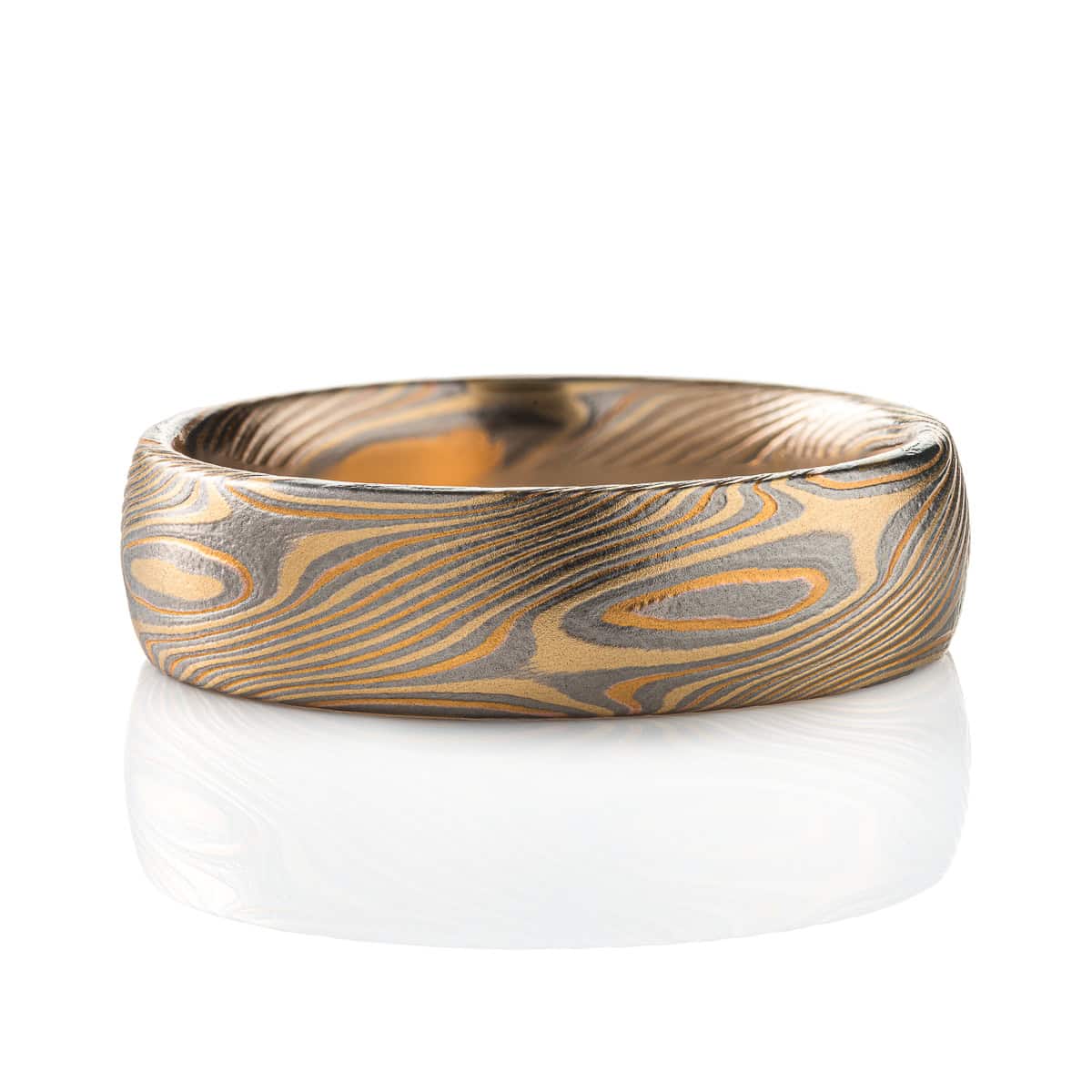 Mokume gane all gold ring patterned in twisting swirling pattern. Made with two shades of gold and darker palladium.