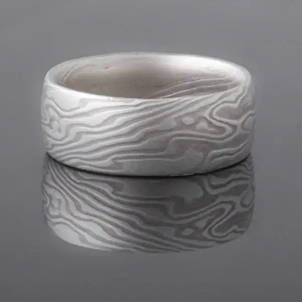 mokume gane shibuichi ring, made of light and dark gray metals in a twisting pattern