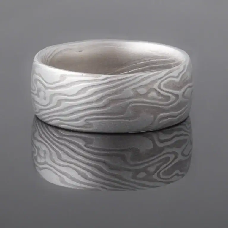 mokume gane shibuichi ring, made of light and dark gray metals in a twisting pattern