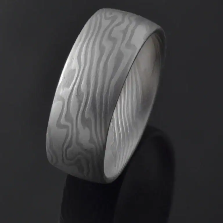 mokume gane shibuichi ring, made of light and dark gray metals in a twisting pattern