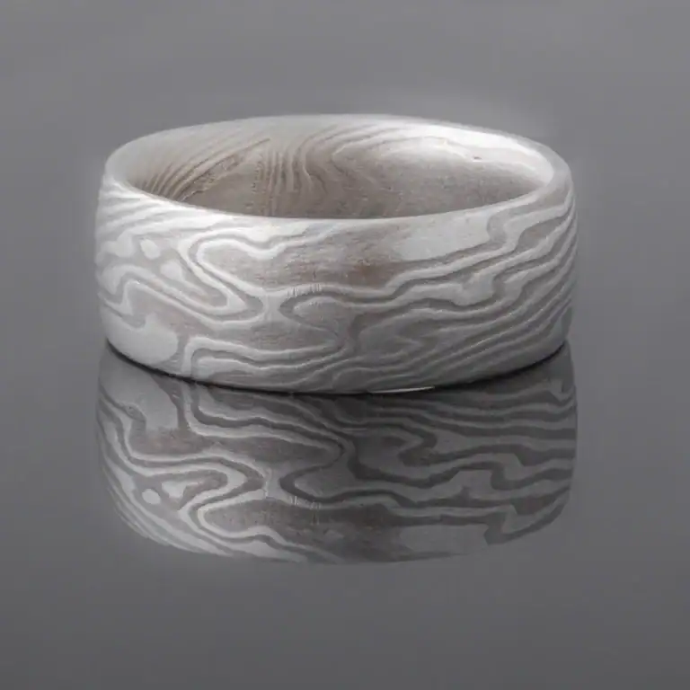 mokume gane shibuichi ring, made of light and dark gray metals in a twisting pattern