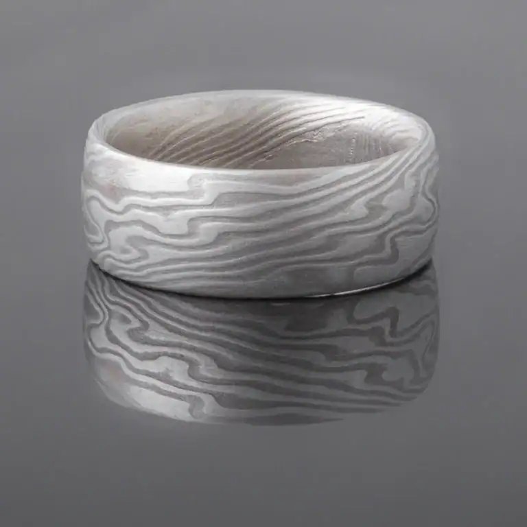 mokume gane shibuichi ring, made of light and dark gray metals in a twisting pattern
