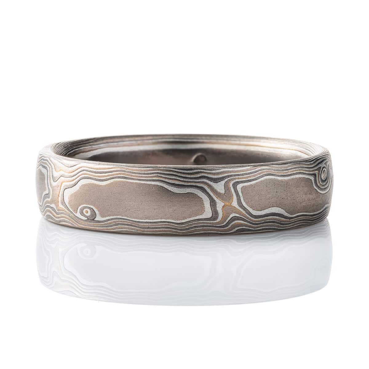 Mokume gane gray toned band, made to resemble woodgrain. Smooth surface, made with white gold, palladium and silver. .