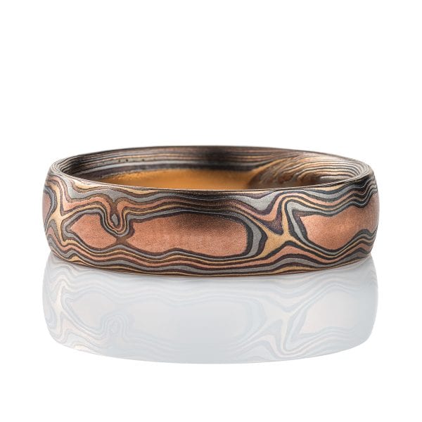 Mens style mokume gane woodgrain patterned band, made with red gold, yellow gold, palladium and silver.
