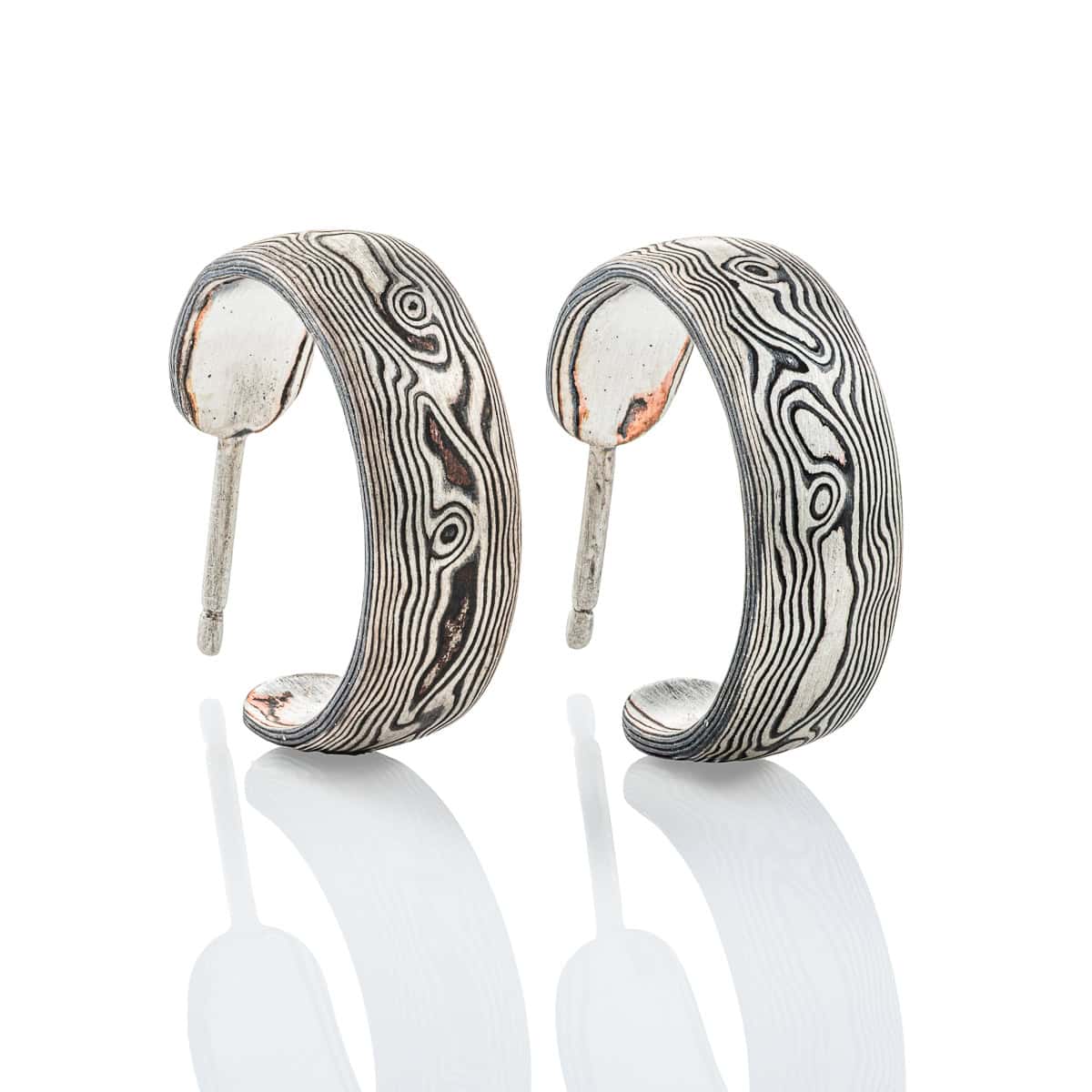 Pair of mokume gane open hoop earrings with posts. Patterned to look like woodgrain.