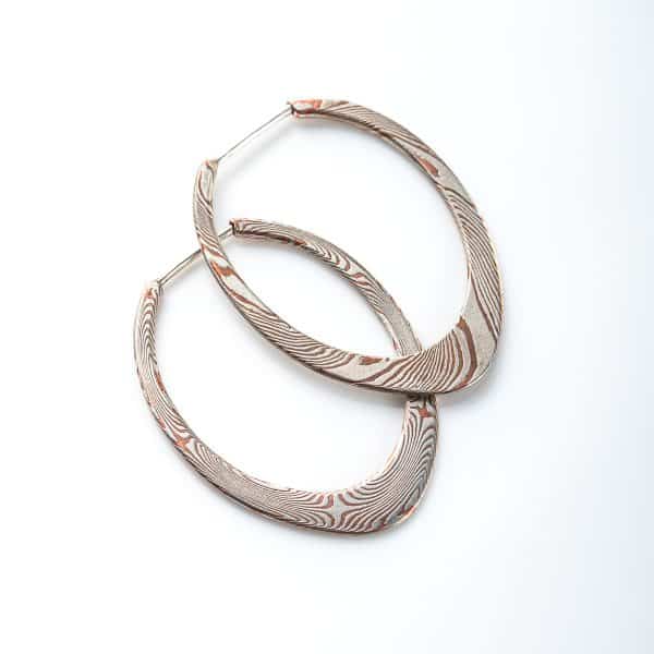 pair of mokume gane patterned hoops, flat profile, apogee shape, made with copper and silver