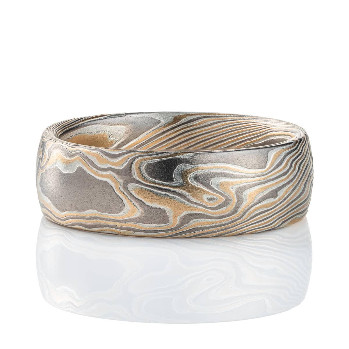 Wide men's style mokume gane ring, patterned in a Twist style, made with yellow gold, palladium and silver.