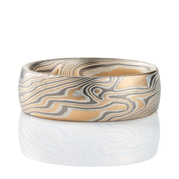 Wide men's style mokume gane ring, patterned in a Twist style, made with yellow gold, palladium and silver.