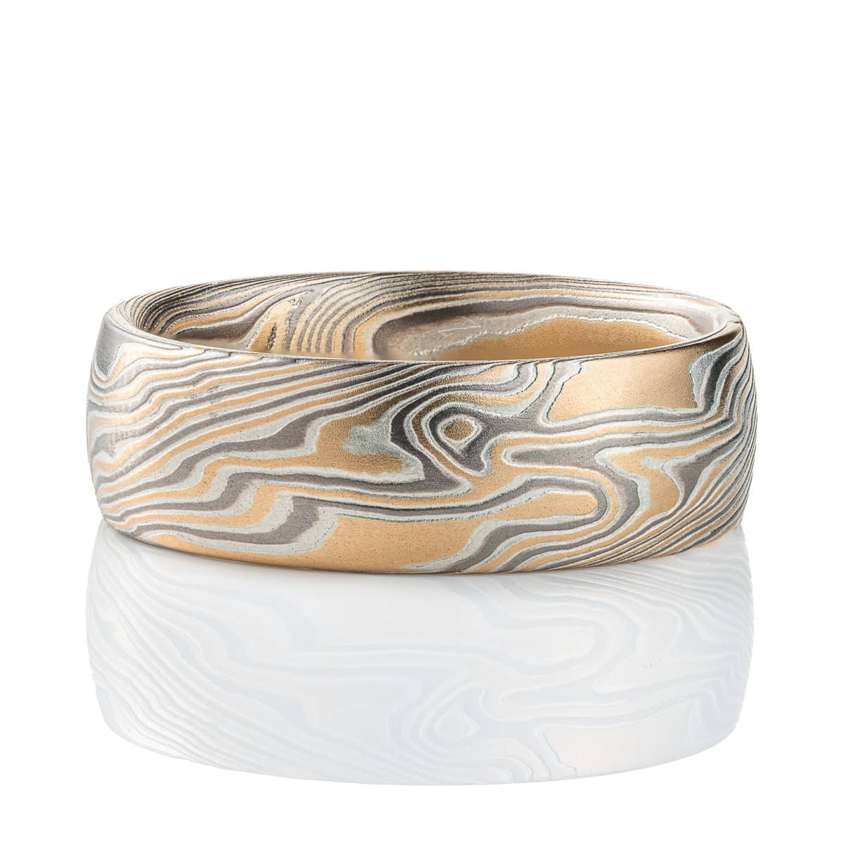 Wide men's style mokume gane ring, patterned in a Twist style, made with yellow gold, palladium and silver.
