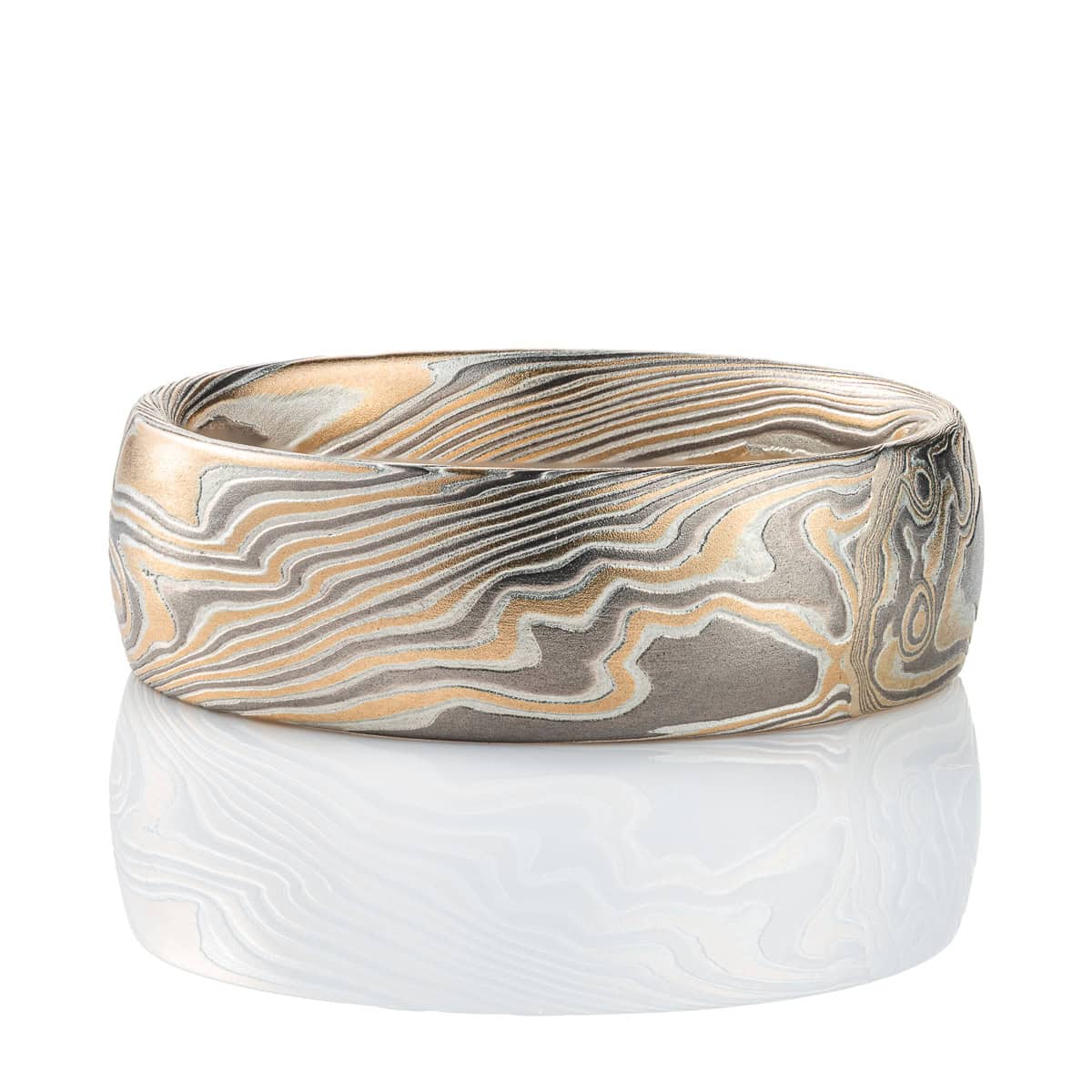 Wide men's style mokume gane ring, patterned in a Twist style, made with yellow gold, palladium and silver.