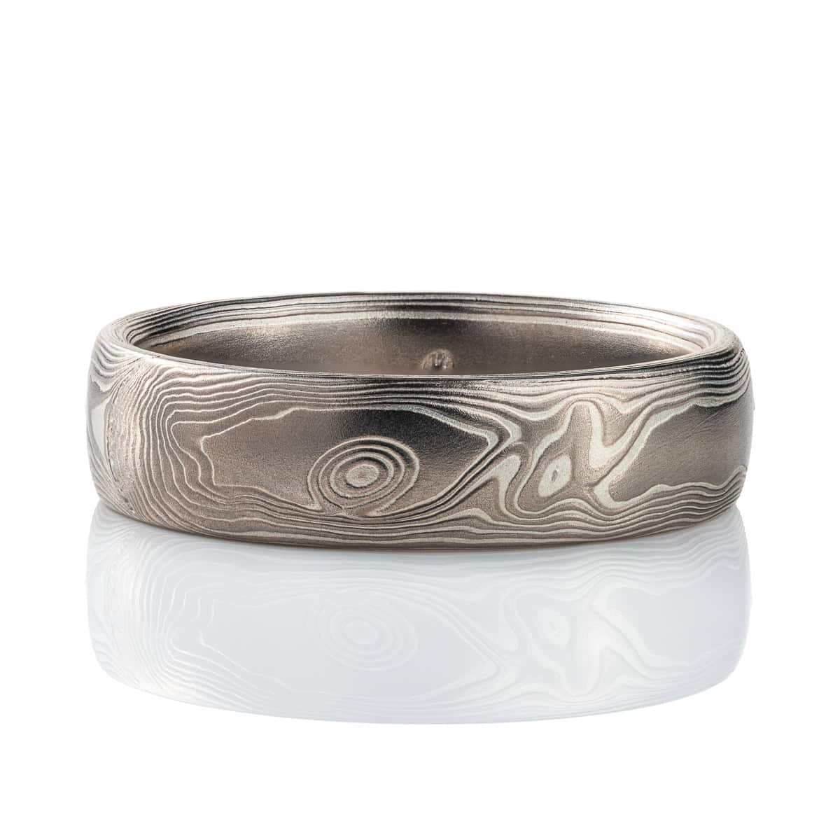 Mokume gane band patterned to resemble woodgrain, made with layers of palladium and silver. .