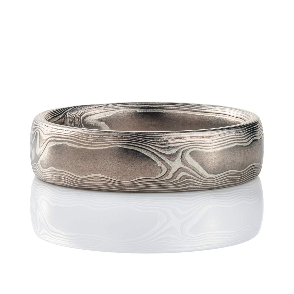 Mokume gane band patterned to resemble woodgrain, made with layers of palladium and silver. .