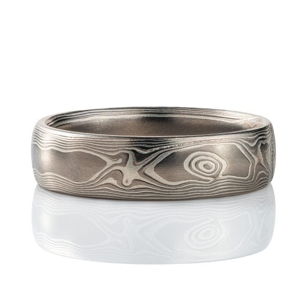 Mokume gane band patterned to resemble woodgrain, made with layers of palladium and silver. .