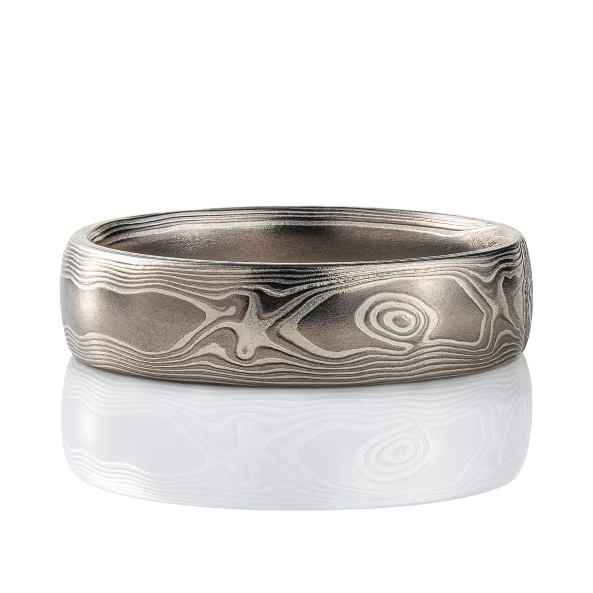 Mokume gane band patterned to resemble woodgrain, made with layers of palladium and silver. .