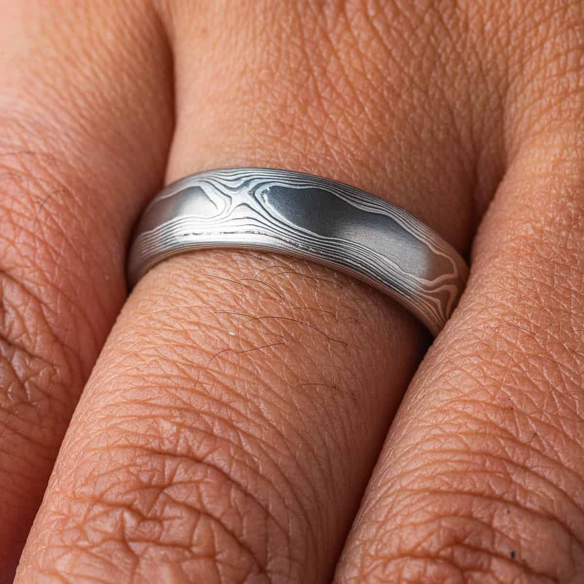 Mokume gane band patterned to resemble woodgrain, made with layers of palladium and silver. .