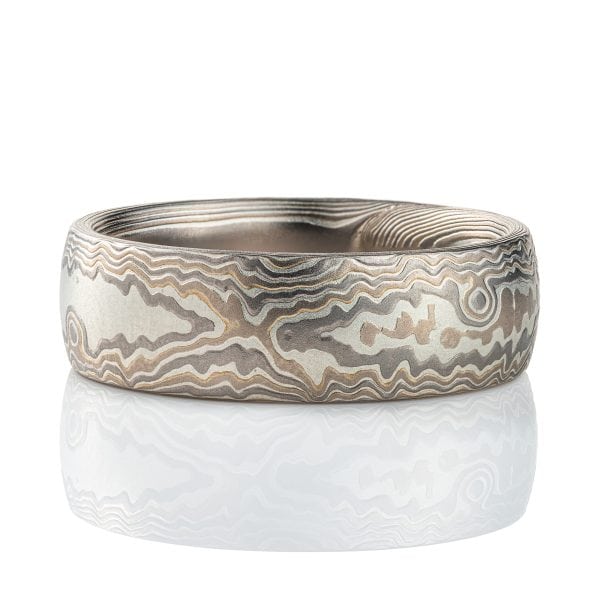 Wide, large mokume gane men's ring, patterned to look like carved woodgrain. Made with layers of white gold, palladium and silver, with an etched finish for texture.