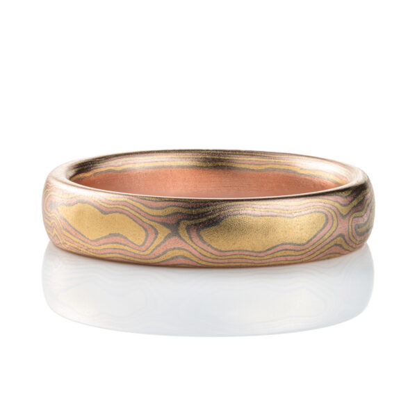 All gold mokume gane patterned band, made to resemble woodgrain, with layers of red and yellow gold with palladium in between.