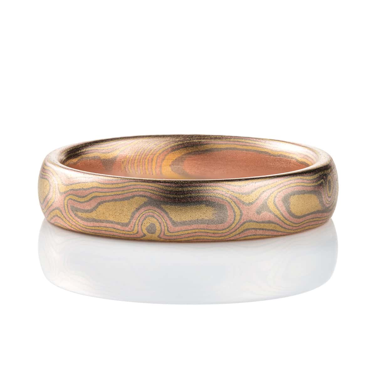 All gold mokume gane patterned band, made to resemble woodgrain, with layers of red and yellow gold with palladium in between.