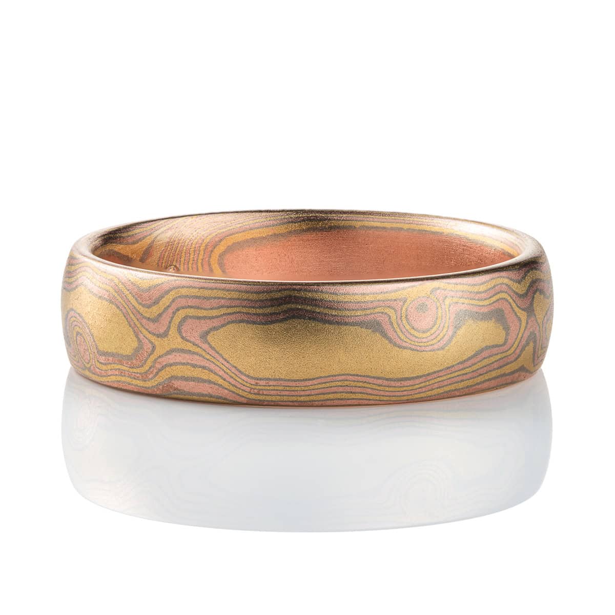 All gold mokume gane patterned band, made to resemble woodgrain, with layers of red and yellow gold with palladium in between.