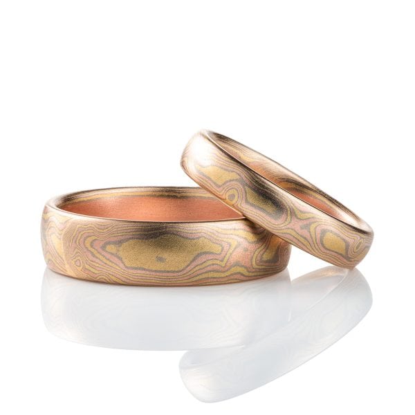 Pair of matching mokume gane rings patterned to resemble woodgrain, made with all gold